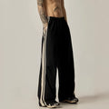 Men's black climbing trousers with high waist and wide straight leg design on hanger