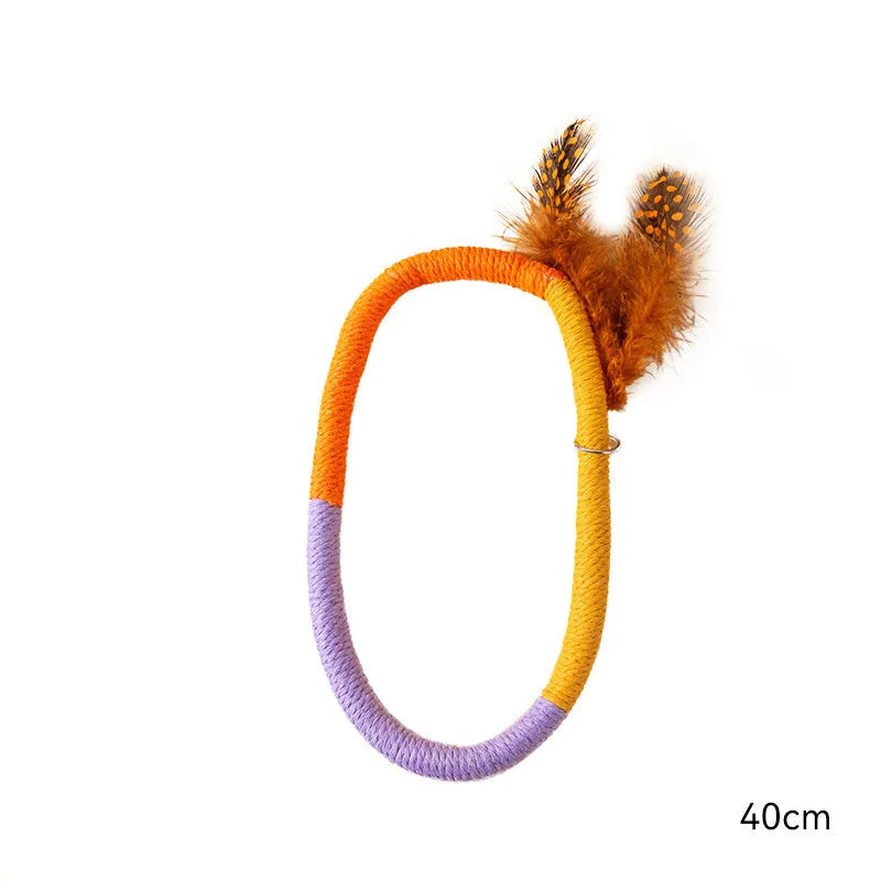 Circular green cotton rope cat toy with feathers and catnip filling for chewing and interactive play