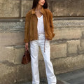Retro loose fit solid colour polyester jacket with long sleeves on a model.