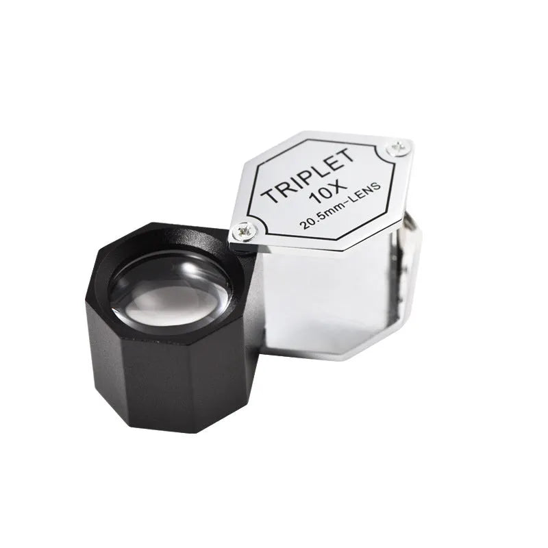 Handheld metal magnifying glass with optical glass lens for jewellery, stamp, and coin identification.