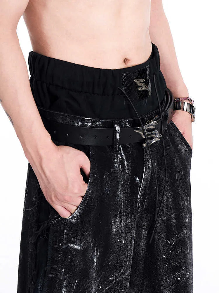 Black men's leather belt with metal letter detail showing two-layer cowhide construction