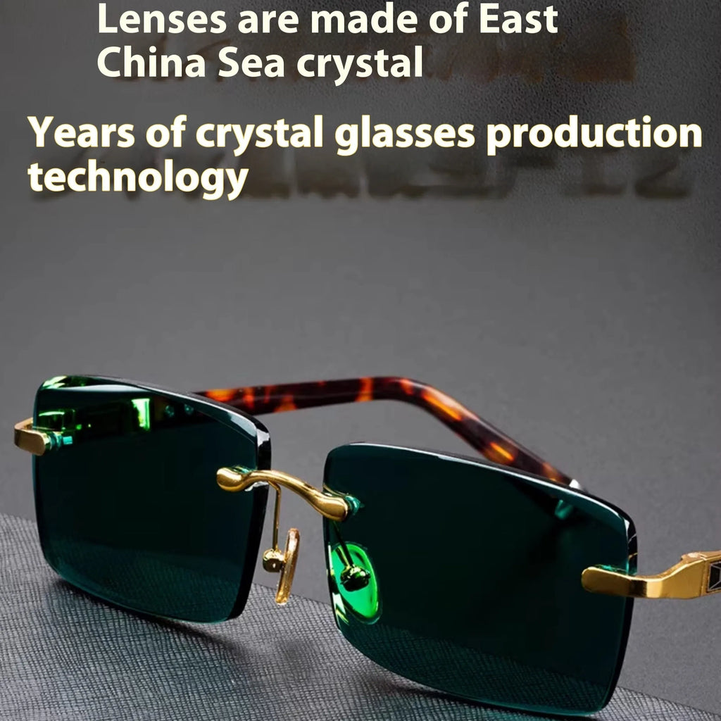 A pair of frameless sunglasses with dark green crystal lenses, shown with a soft case and cleaning cloth.