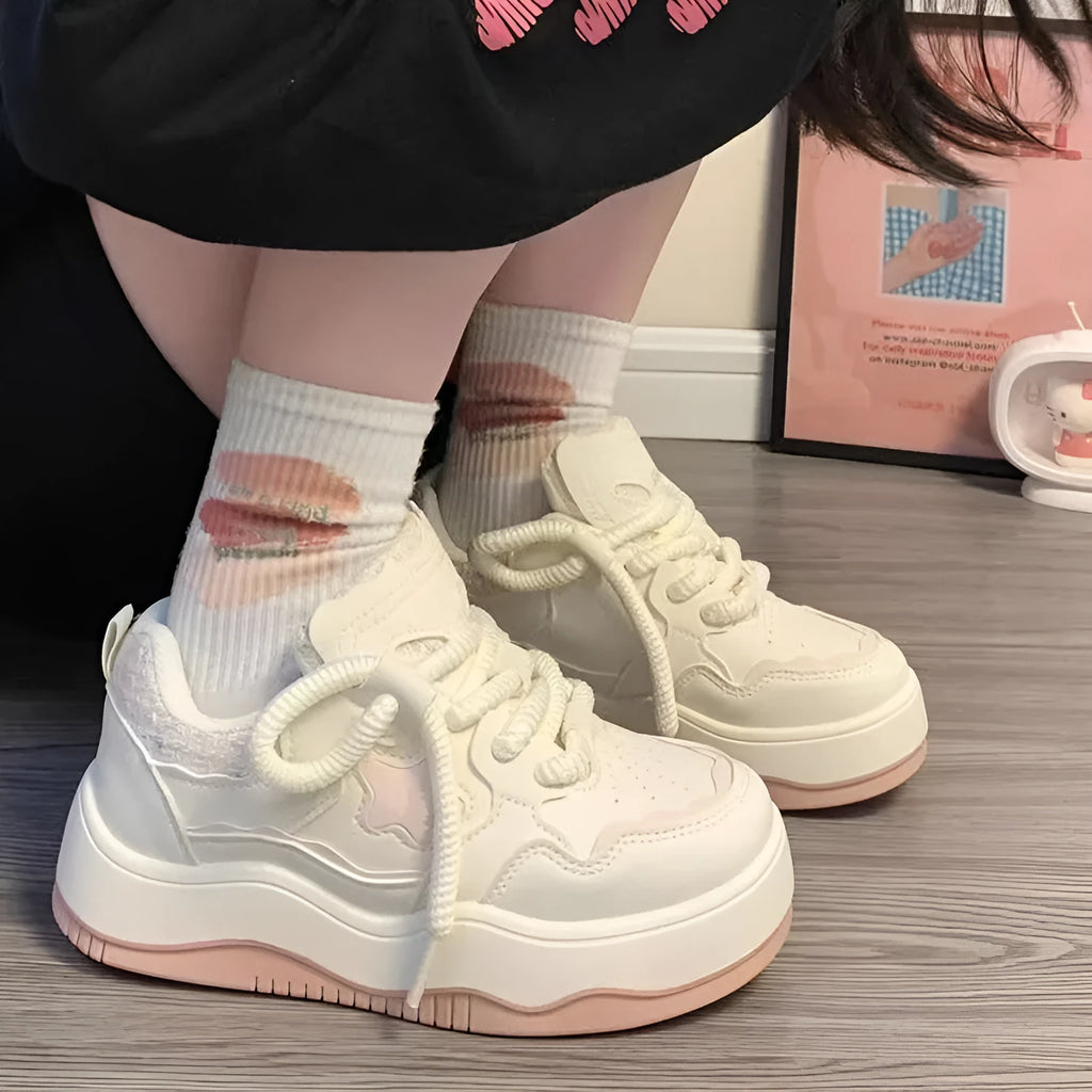 Women's green platform sneakers with round toe and lace-up design on a white background.