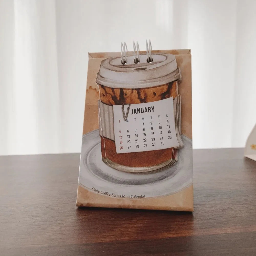 Mini coffee-themed desk calendar showing 2025 dates with motivational text