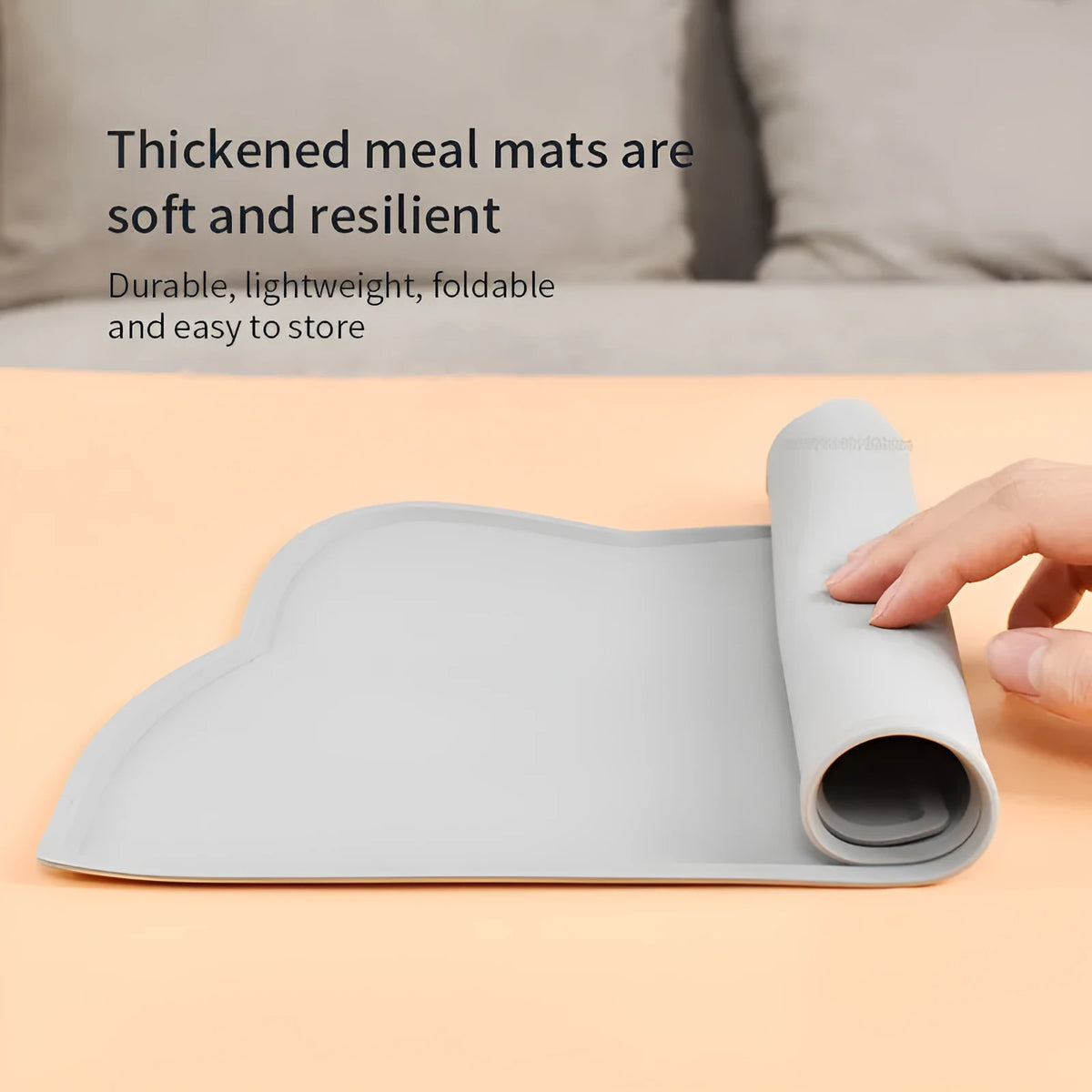 Blue silicone waterproof pet feeding mat for dog or cat food bowls on a wooden floor.