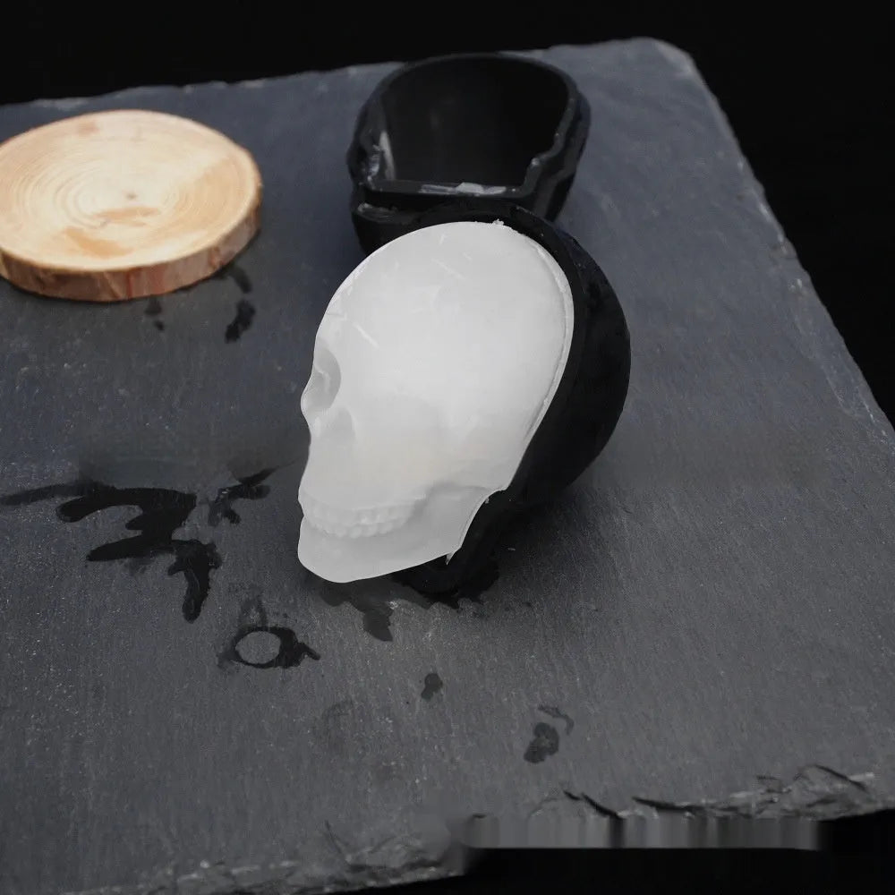 3D Halloween skull-shaped silicone ice cube tray on a table.