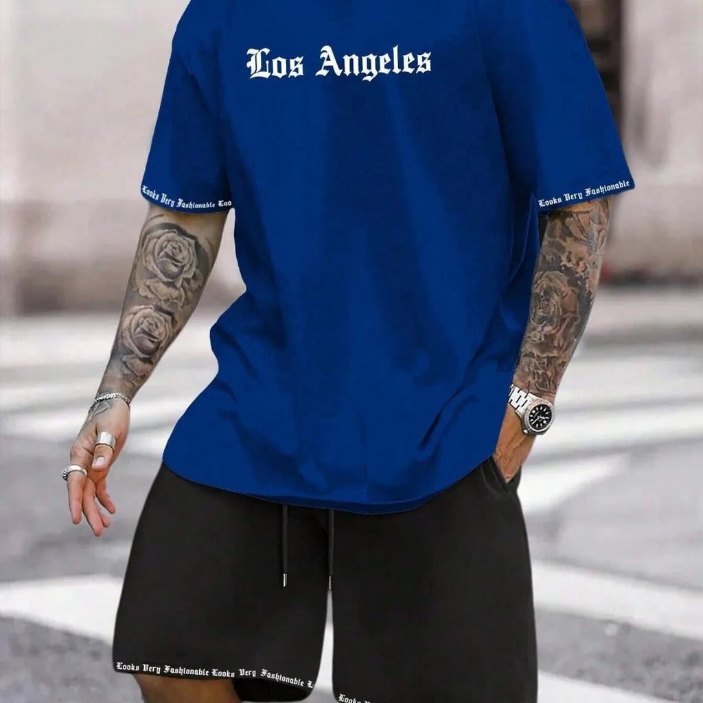 Man wearing a grey short-sleeve top and matching shorts from a sports co-ord set.