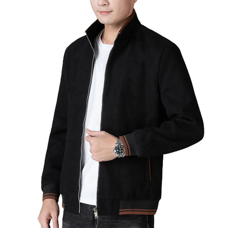 Man wearing a grey fleece sports jacket with a stick pocket on the chest.