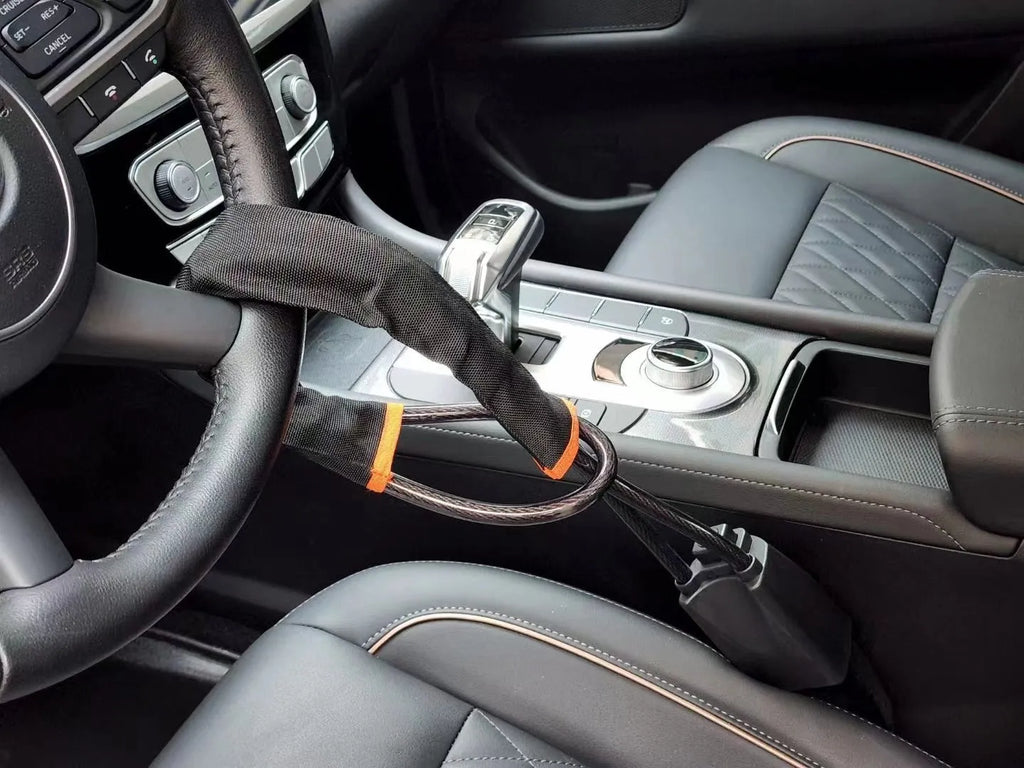 General Motors car steering wheel lock in red with iron construction and copper lock core measuring 33cm