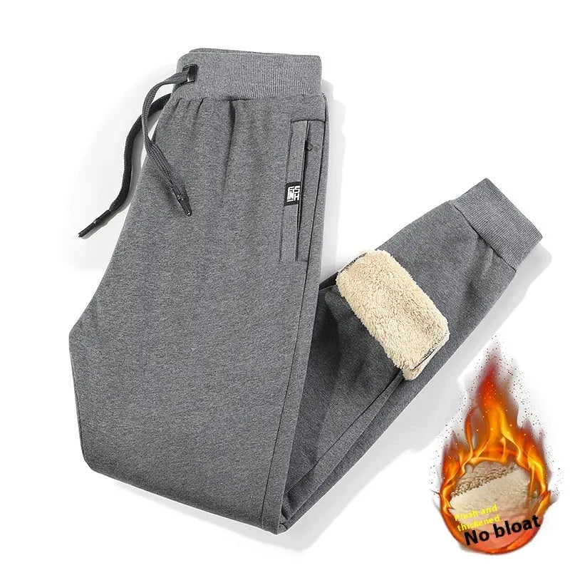Men's grey fleece-lined oversized cotton track pants with a straight leg on a hanger.