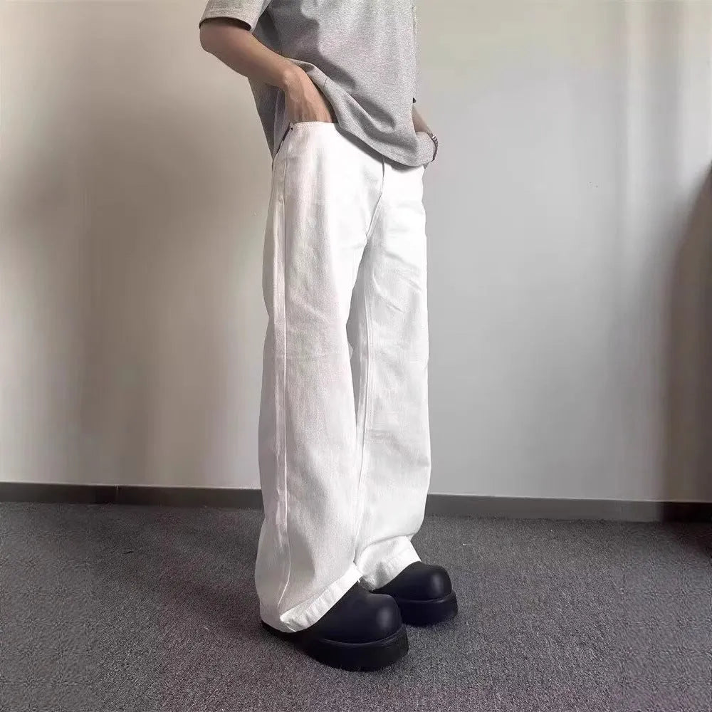 White men's straight-leg jeans with a wide loose cut on a mid waist, featuring a zipper fly.
