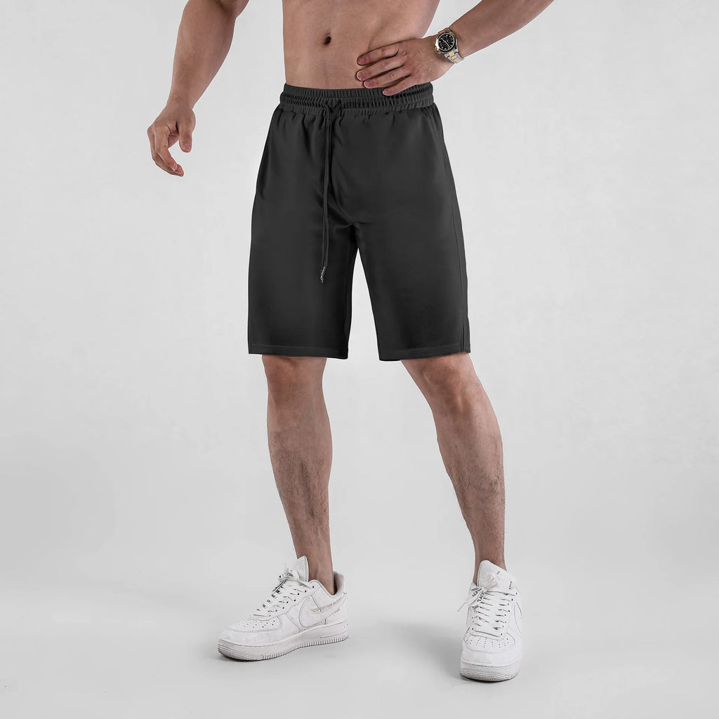 Men's black quick-dry mesh shorts with elastic waist, shown in a loose, casual fit.