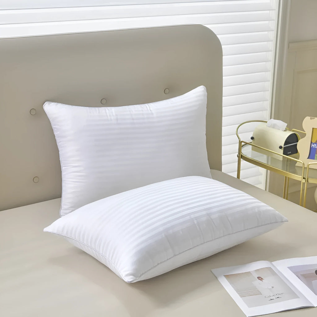 White cotton satin stripe feather and cotton pillow showing three size options
