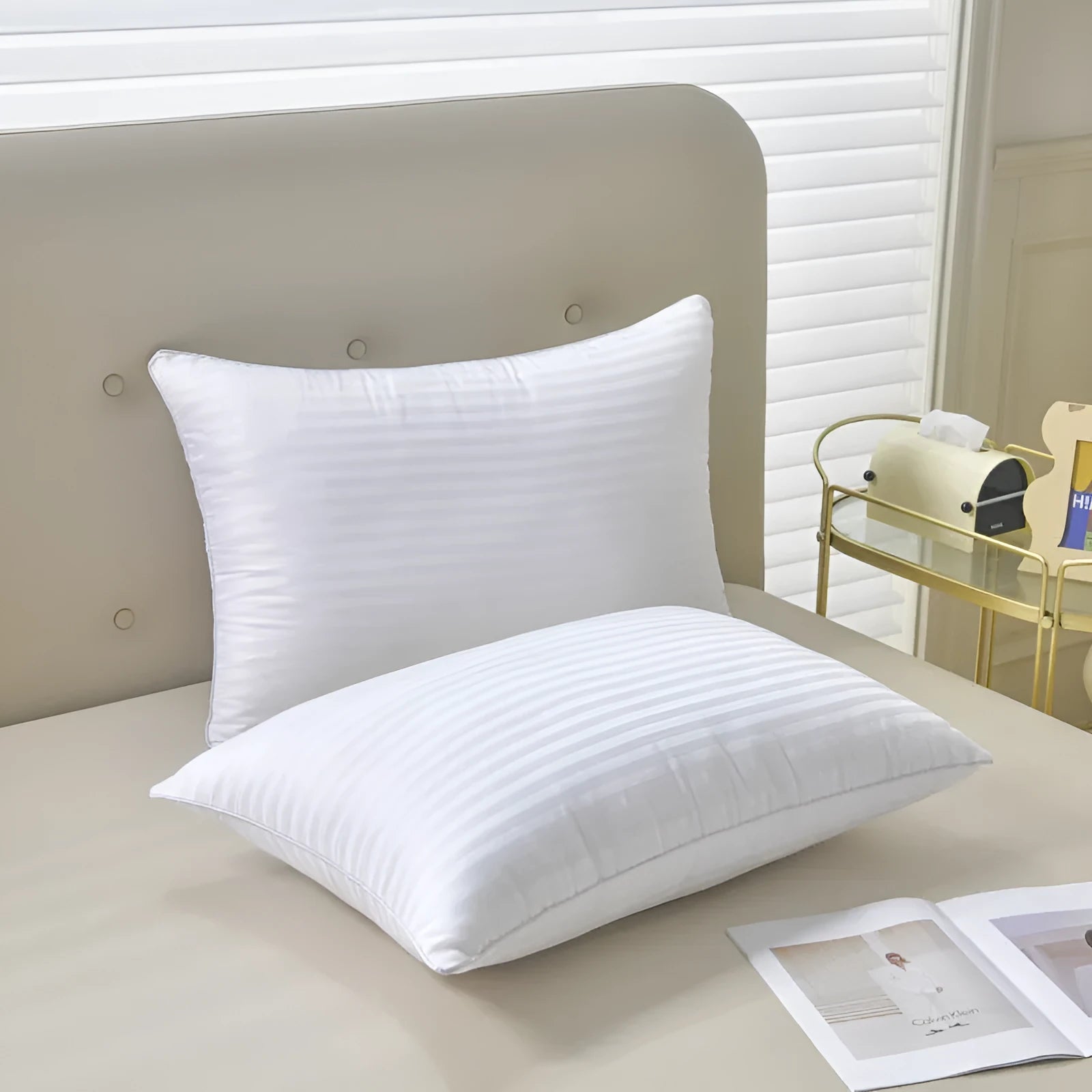 White cotton satin stripe feather and cotton pillow showing three size options