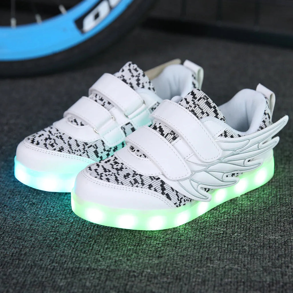 USB rechargeable children's LED light up trainers in plum red and white showing flashing soles.