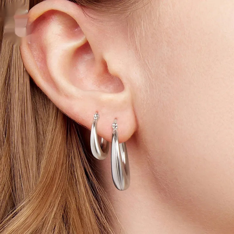 Copper ring ear clip earrings with a silver needle, shown in classic geometry design.