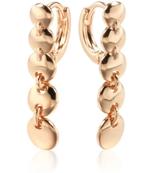 Retro long round copper earrings with woven design in a gold colour finish.