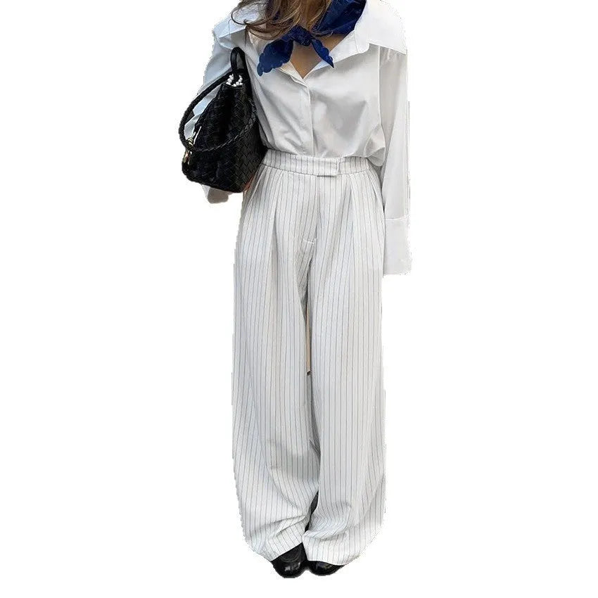 White striped wide-leg loose fit trousers with zipper front on a hanger