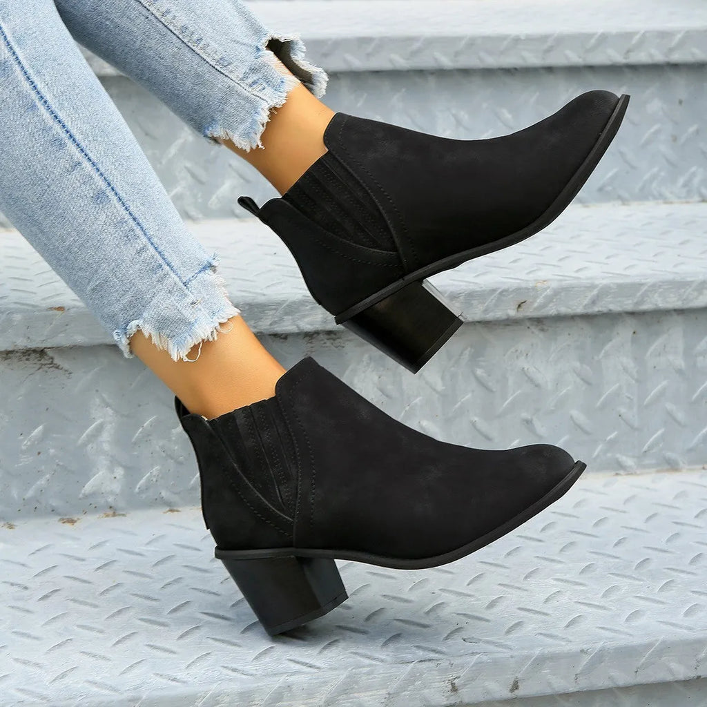 Women's black pointed toe ankle boots with thick square heel and slip-on design