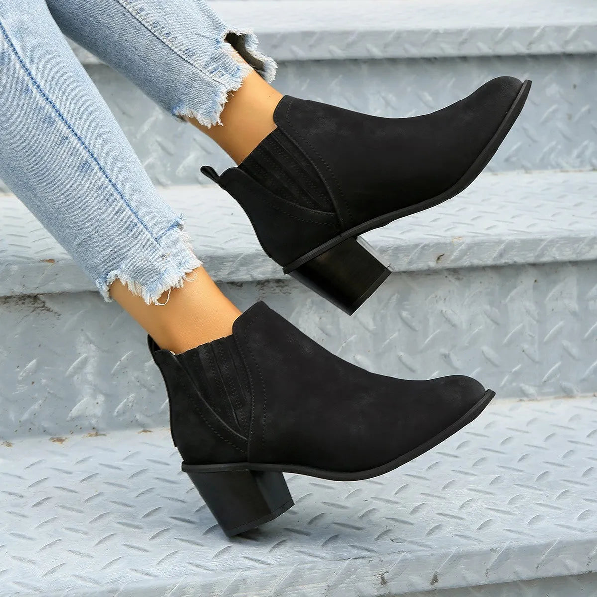 Women's black pointed toe ankle boots with thick square heel and slip-on design
