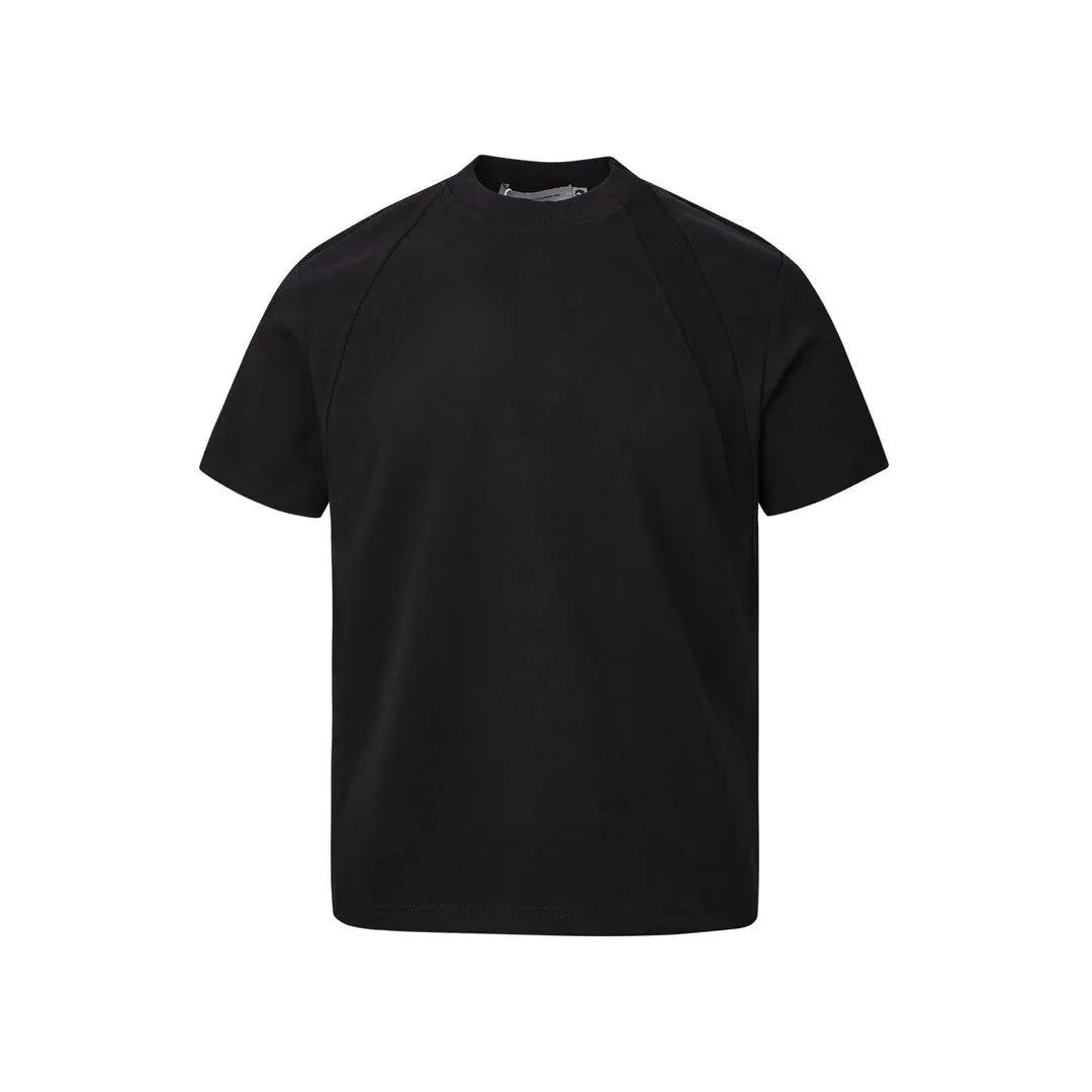 Man wearing a loose-fit black short-sleeve polyester top with air layer stitching.
