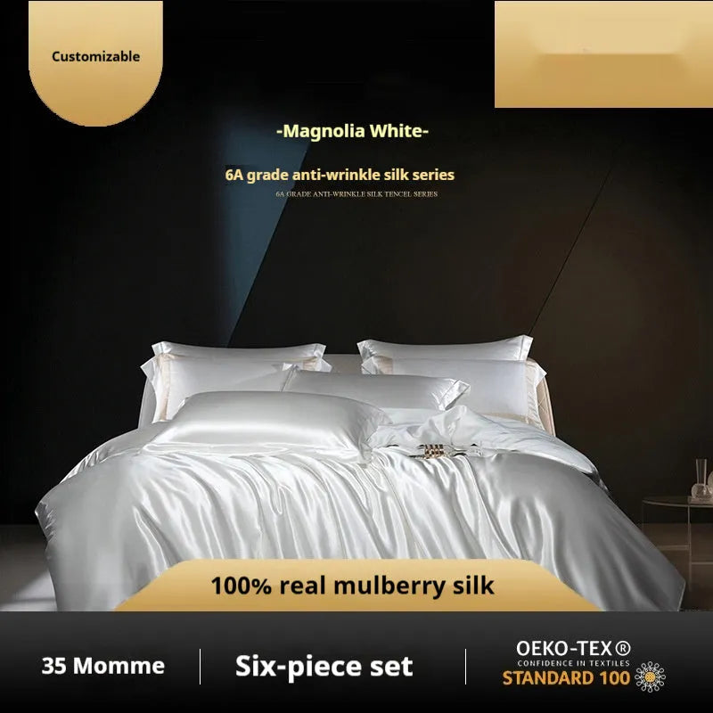 Solid colour silk four-piece quilt cover set shown in a light luxury bedroom setting.
