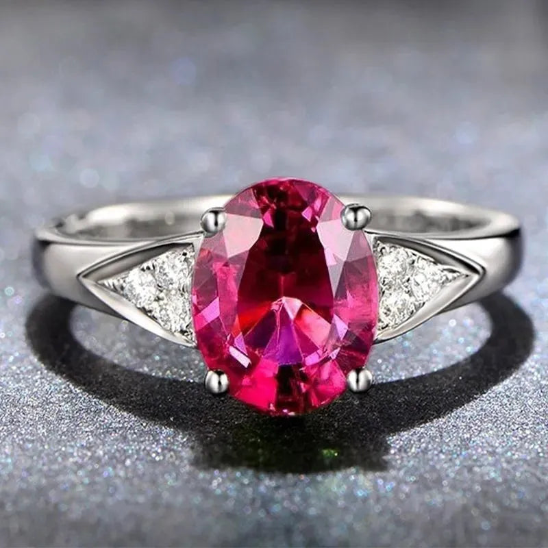 Women's court ring with natural blue zircon stones set in a delicate heart pattern on a silver-toned band.