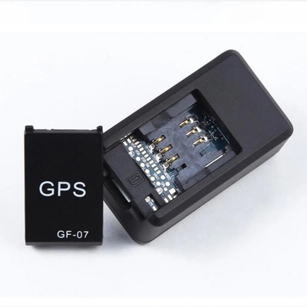 Small black magnetic GPS tracker device for cars with a USB charging cable.