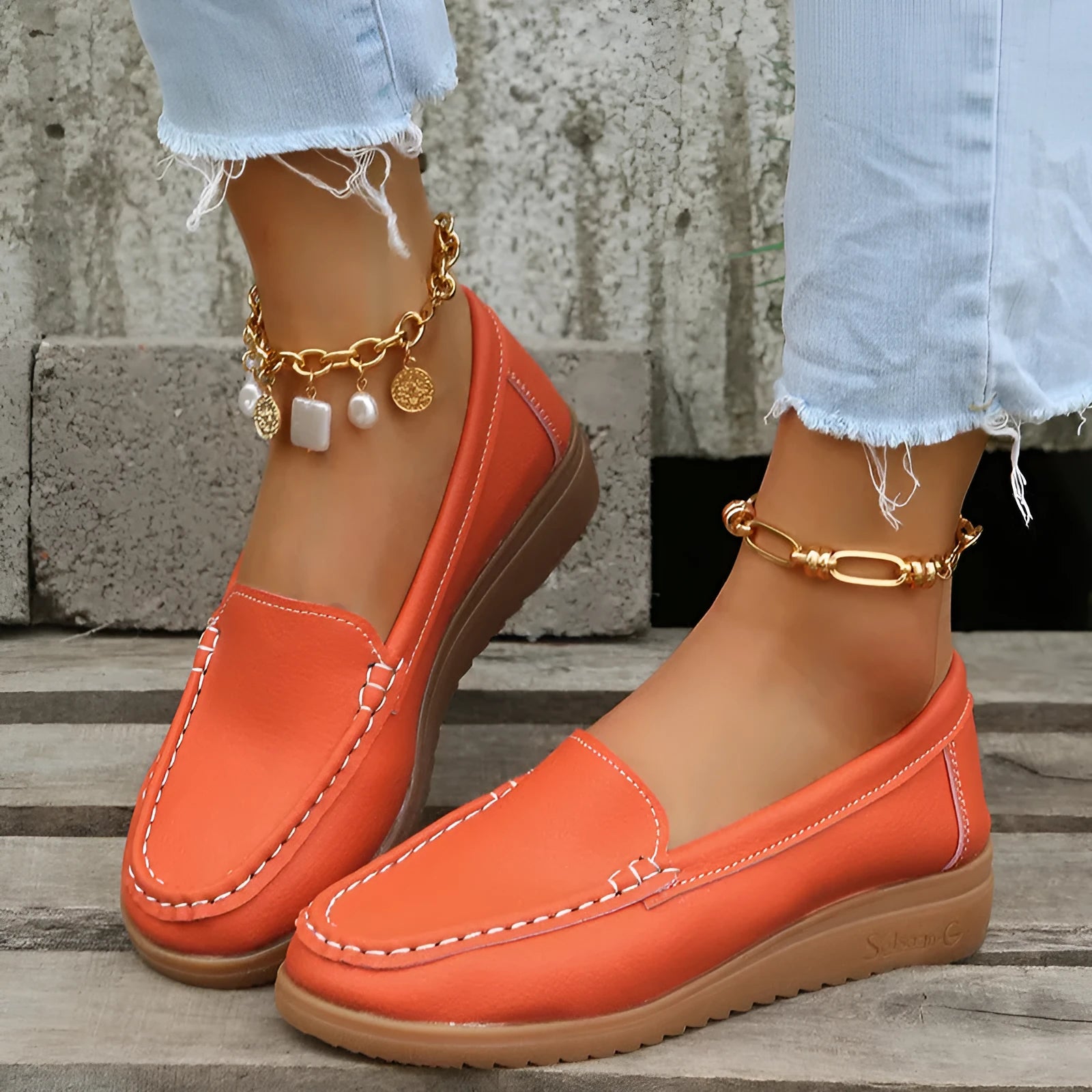 Women's flat loafers in PU leather showing round toe, car suture detail, and a flat rubber sole.