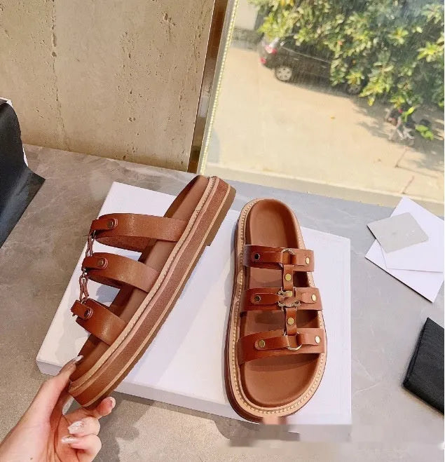 Women's black retro Roman gladiator sandal slippers made from patent leather and sheepskin.