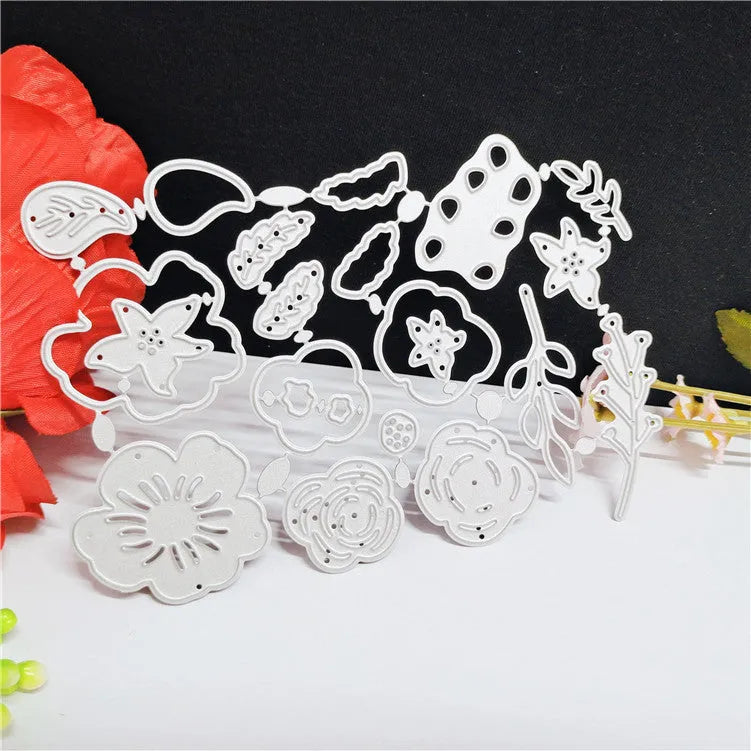 Silver carbon steel paper cutting mould with etched floral design measuring 14.3 by 9.9 centimetres