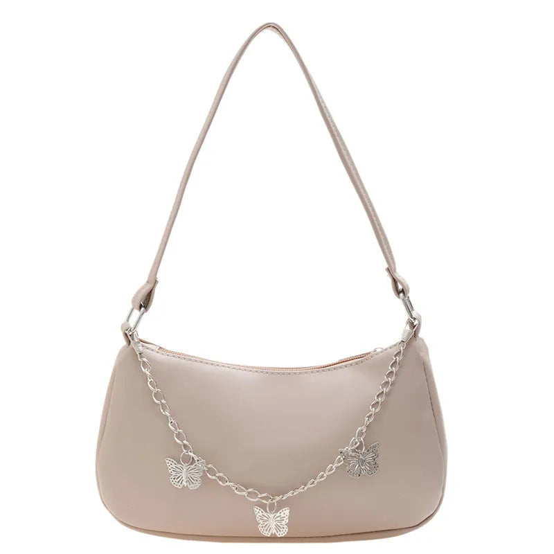 Women's black butterfly design chain underarm bag with a squared shape and three-dimensional pocket.