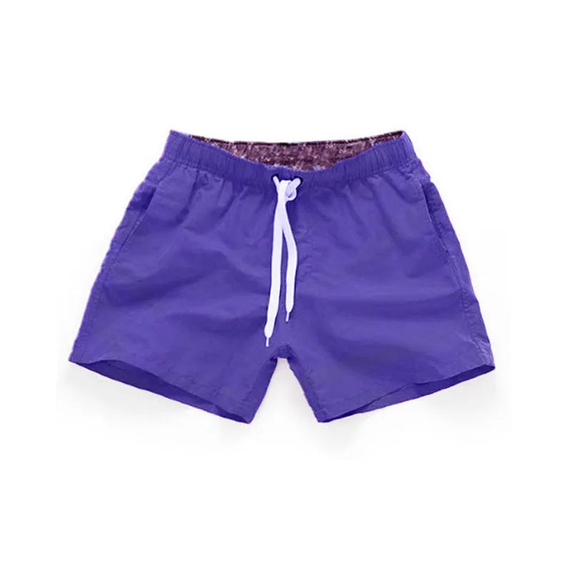 Men's polyester beach shorts for surfing in multiple colours including black white red and fluorescent options