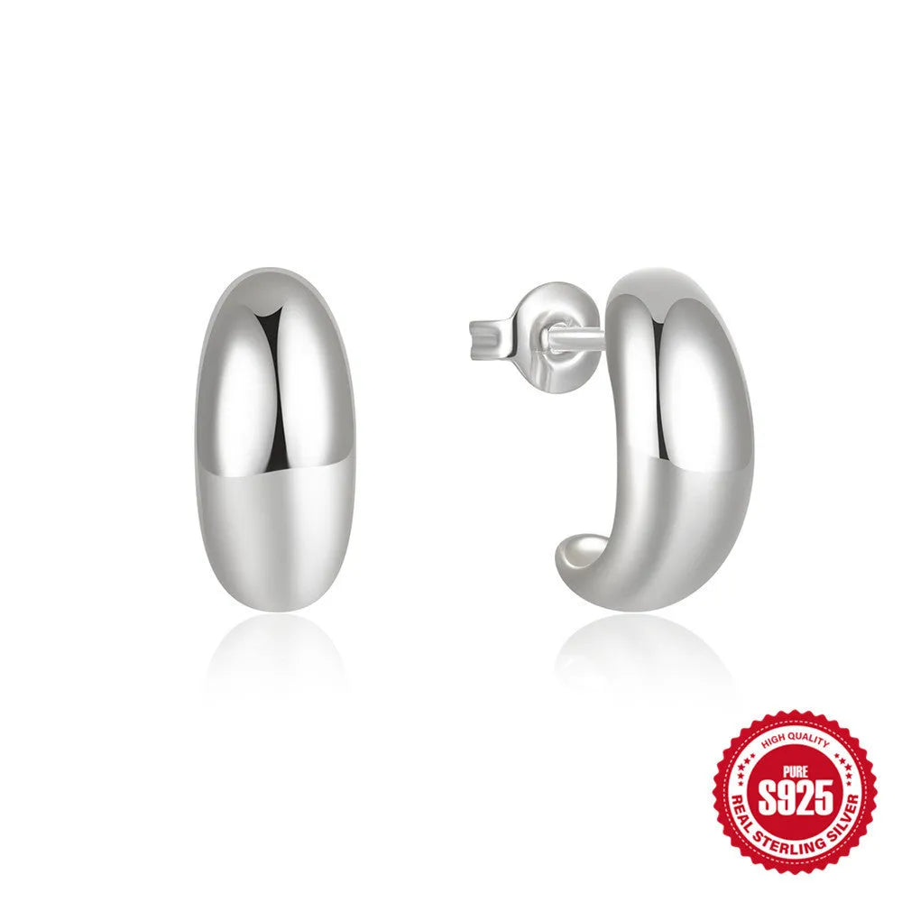 A pair of glossy C-shaped stud earrings in sterling silver, shown in gold and silver colour options.