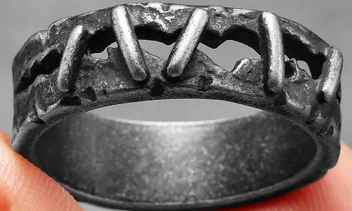 Stainless steel double finger ring with punk-style stitching details, shown in a dark colour.