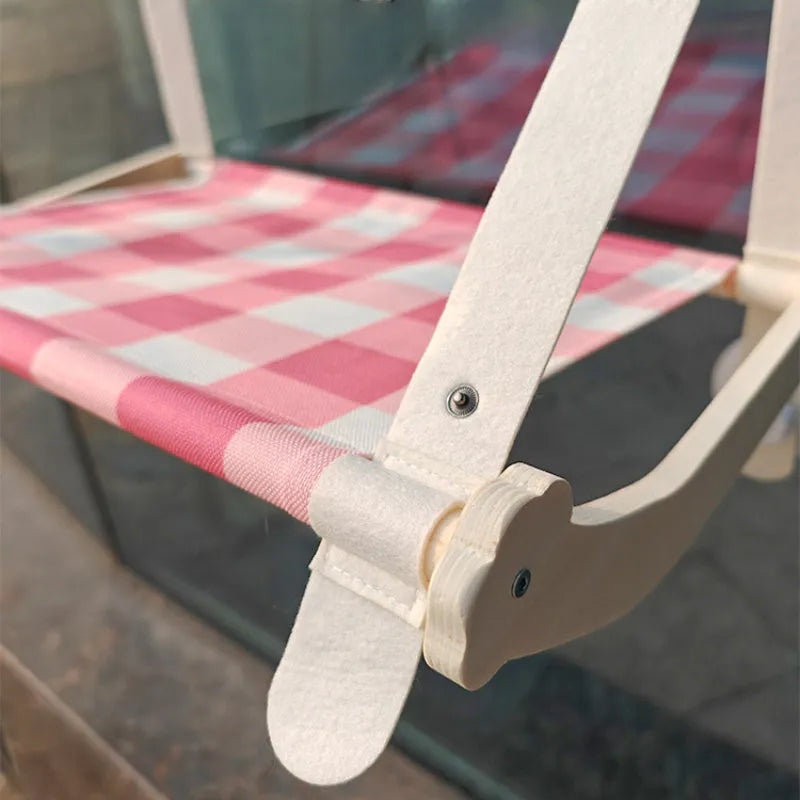 Wooden cat window hammock with linen fabric attached to window using suction cups