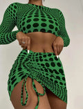 Women's green and yellow polka dot polyester swimsuit three-piece set showing top, skirt, and bra.