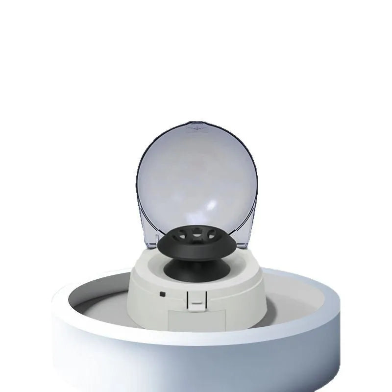 Small white laboratory mini centrifuge unit on a benchtop.