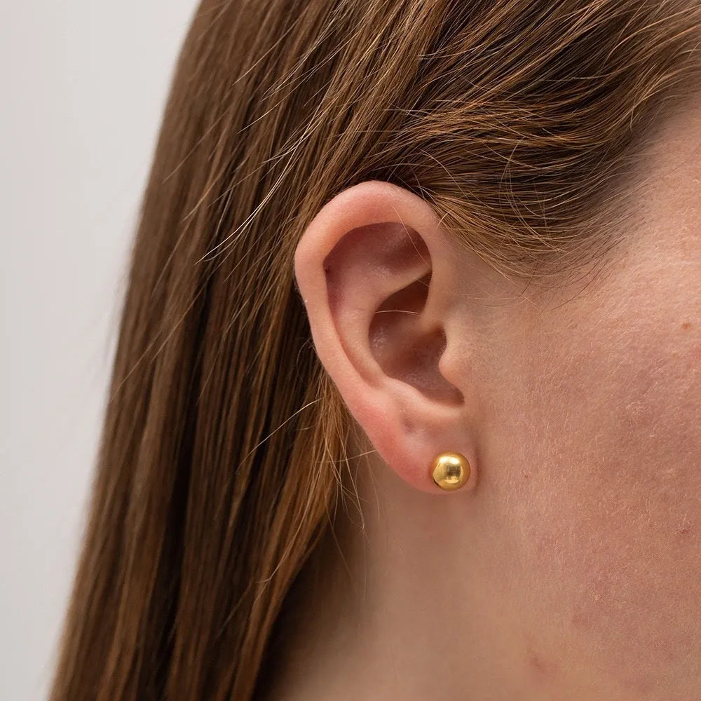 Gold and silver minimalist ball stud earrings in 3mm, 4mm, 5mm, and 6mm sizes on a plain background.