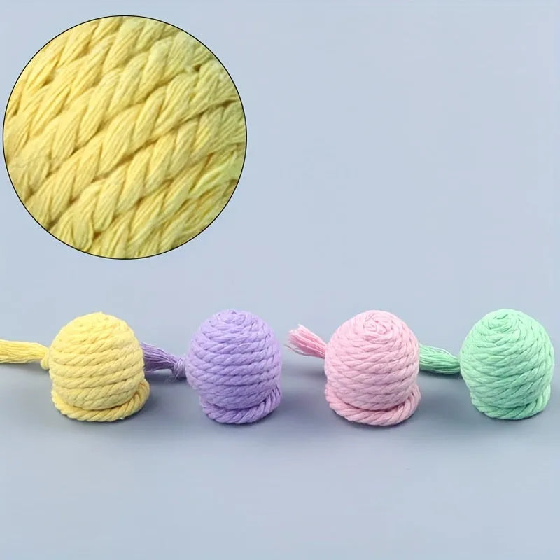 Colourful cat toy ball with rope attachment and internal bell for interactive kitten play