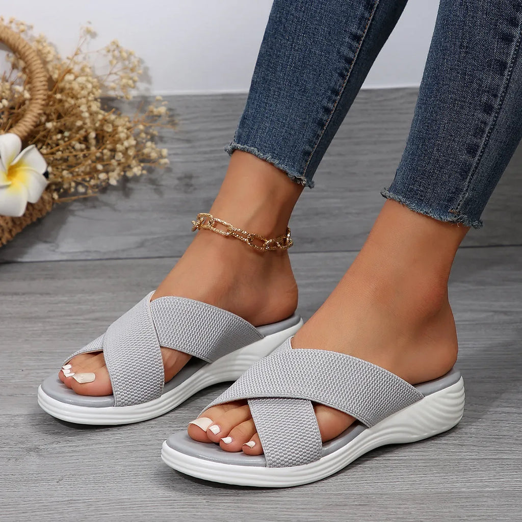 Women's black peep-toe wedge slippers with a thick flat rubber sole