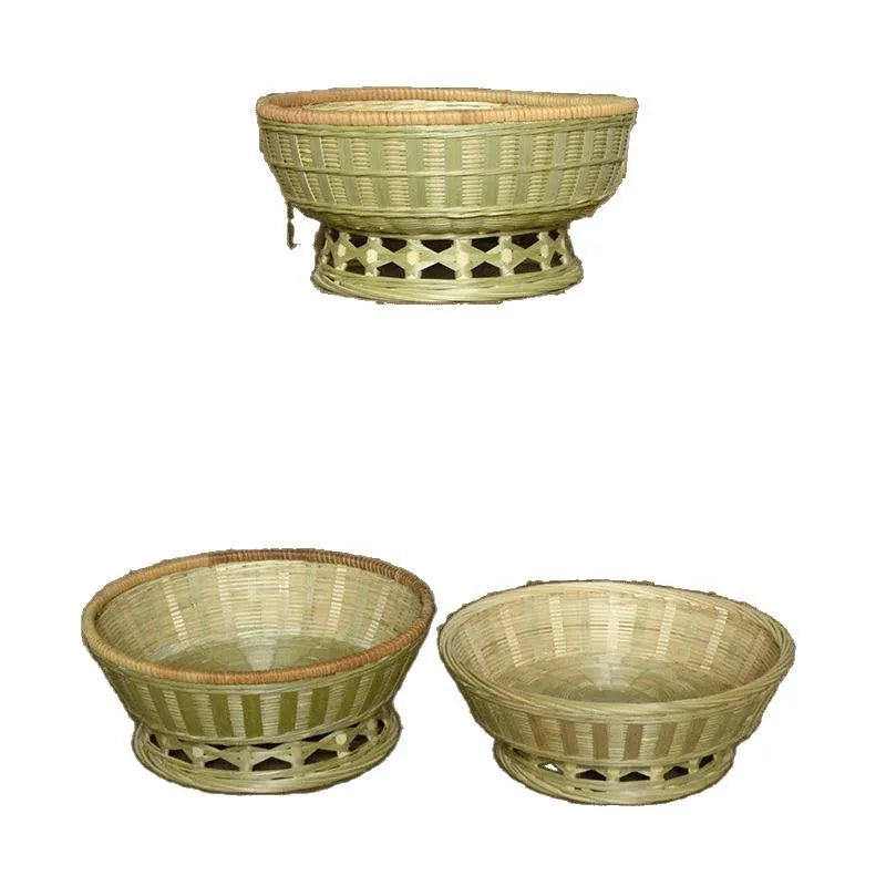 Handmade natural bamboo woven storage basket in three different sizes on a table.