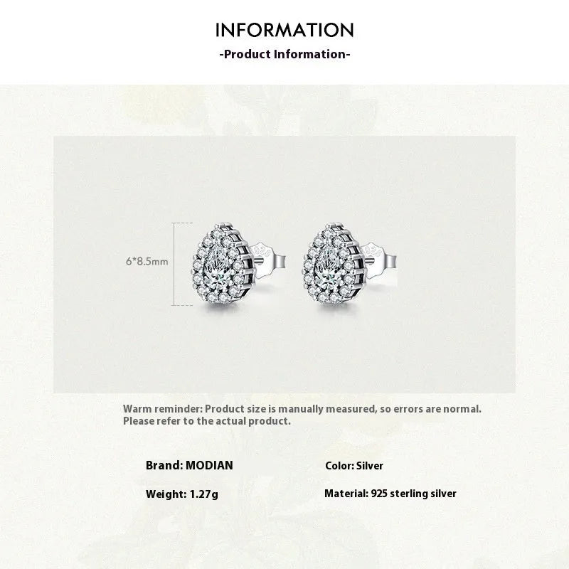 Close-up of women's sterling silver water drop shaped ear studs with diamond cut facets on a white background.