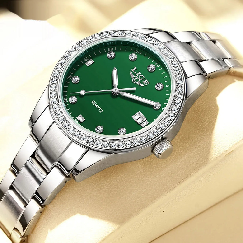 Women's silver fashion quartz watch with diamond bezel, luminous hands on a coloured dial, showing side profile with spiral crown.