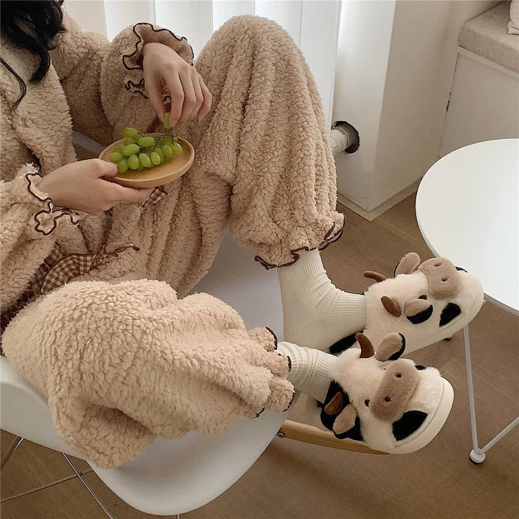 White cow-themed women's plush slippers with faux fur upper and textured non-slip sole