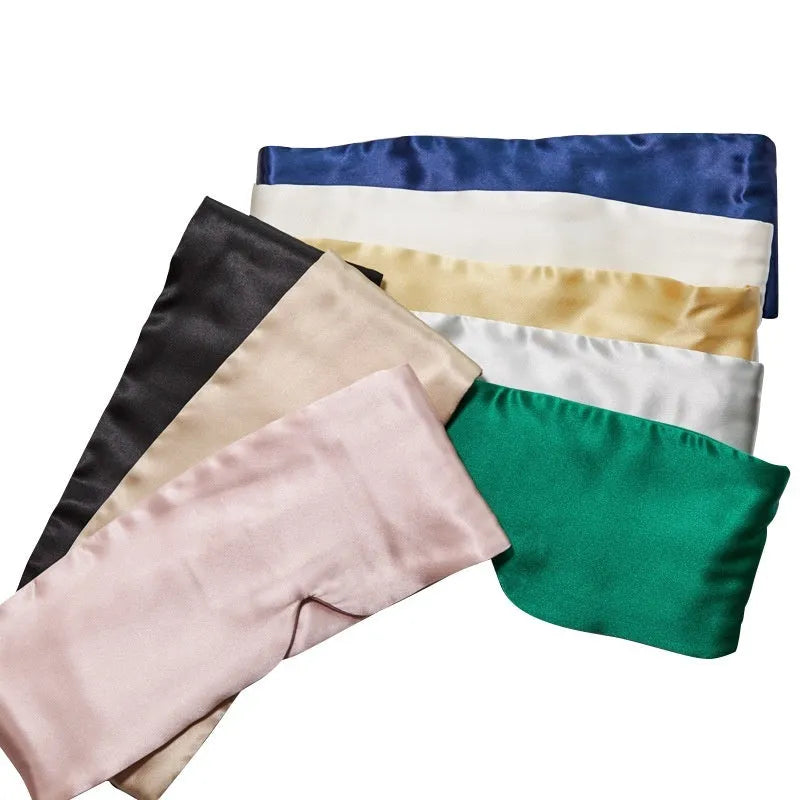 Mulberry silk sleep mask in champagne gold colour, shown folded.