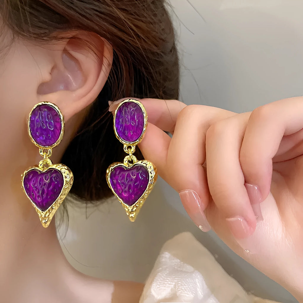 Silver pleated heart-shaped stud earrings in purple, red, green, and yellow/white colours.