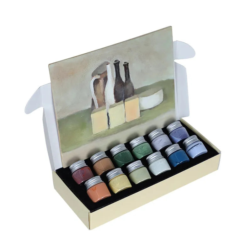Pots of Morandi colour ceramic glaze paint in Lilac, Plant Ash, and Verdant for high temperature pottery firing.