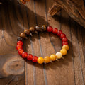 Bohemian-style long necklace chain with vintage tassel and matching bracelet on dark background