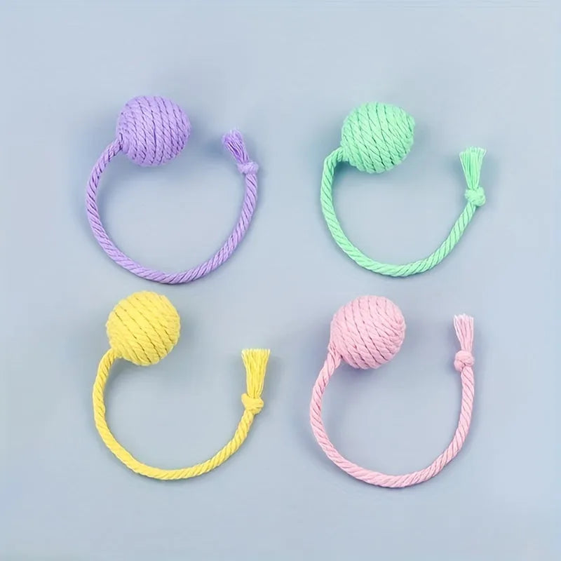 Colourful cat toy ball with rope attachment and internal bell for interactive kitten play